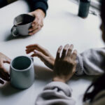 Group of people collaborating around a table, symbolizing artificial intelligence chat and collaboration