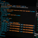 turned on monitor displaying programming language