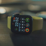 Apple Watch SE stands on the black table