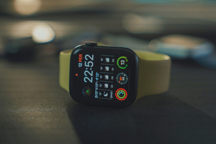 Apple Watch SE stands on the black table