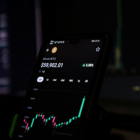 Cell phone displaying a stock chart indicating Ethereum cryptocurrency trends