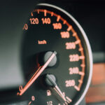 Closeup photo of black analog speedometer in a Dodge car 2025